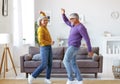 Energetic senior family couple dancing together in living room at home, moving to music Royalty Free Stock Photo