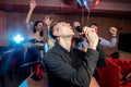 Energetic singer man in karaoke bar Royalty Free Stock Photo