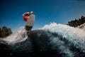 Energetic sporty man jumping on wave on surf style wakeboard Royalty Free Stock Photo