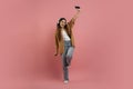 Energetic teen girl listening music on smartphone and dancing Royalty Free Stock Photo