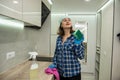energetic woman cleans kitchen with modern means of cleaning dirt in inaccessible places. Royalty Free Stock Photo