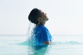 Energetic young boy jump out from a swimming pool Royalty Free Stock Photo