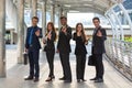 Energetic Young Businesspeople, three businessmen and two Businesswomen showing ok symbol