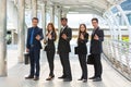 Energetic Young Businesspeople, three businessmen and two Businesswomen showing ok symbol