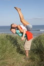 Energetic Young Couple Having Fun In Dunes