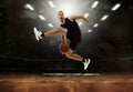Energetic young professional basketball player jumping with ball at basketball court with people fans. Photoreal 3d