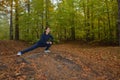 Energetic young woman do exercises outdoors in park to keep their bodies in shape. Fitness concept. Body-building theme. Sport mo Royalty Free Stock Photo