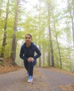 Energetic young woman do exercises outdoors in park to keep their bodies in shape Royalty Free Stock Photo