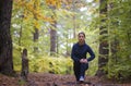 Energetic young woman do exercises outdoors in park to keep their bodies in shape Royalty Free Stock Photo