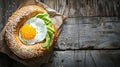 Energizing Breakfast Delight: Bagel with Creamy Avocado and a Perfectly Poached Egg on a Rustic Wood