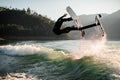 energy man jumping and flips on foil wakeboard over splashing wave Royalty Free Stock Photo