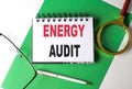 ENERGY AUDIT text on notebook on green paper