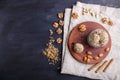 Energy balls cakes with almonds, sesame, cashew, walnuts, dates and germinated wheat in glass jar, top view, black background Royalty Free Stock Photo