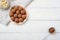Energy balls with dates, keshtyu and cocoa. Vegan food. White wooden background. Good nutrition concept