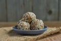Energy balls of nuts, oats and sesame in a blue bowl closeup on wooden background with copyspace. Healthy food. Raw dessert Royalty Free Stock Photo