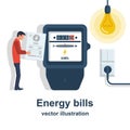 Energy bills. Man paying utilities. Concept of invoice and electricity meter. Royalty Free Stock Photo