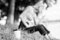 Energy charge and refreshment. Coffee cup take away close up shot. Coffee cup on green grass woman worker with laptop Royalty Free Stock Photo