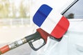 Flag of France on the car`s fuel filler flap with gas pump nozzle in the tank Royalty Free Stock Photo