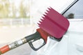 Flag of Qatar on the car`s fuel filler flap with gas pump nozzle in the tank Royalty Free Stock Photo