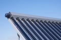 Energy efficiency concept. Closeup of vacuum solar water heating system on the house roof Royalty Free Stock Photo