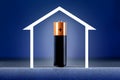 Battery with full of energy and sketch of home against blue background Royalty Free Stock Photo