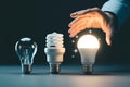 Energy efficient led light bulbs comparison evolution hand selecting best lighting technology choice 100c Royalty Free Stock Photo