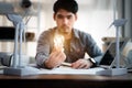 Energy engineer holding light bulb in modern office with solar cell sample and wind turbine model, Creative thinking innovative Royalty Free Stock Photo