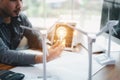 Energy engineer holding light bulb in modern office with solar cell sample and wind turbine model, Creative thinking innovative Royalty Free Stock Photo