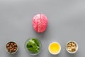 Energy food for brain work with peanut, hazelnut, seed-oil, spinage on gray background top view Royalty Free Stock Photo