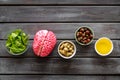 Energy food for brain work with peanut, hazelnut, seed-oil, spinage on wooden background top view Royalty Free Stock Photo