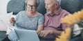 Energy gas bills cost problems in elderly lifestyle. One worried couple of senior at home using laptop to pay bills and check Royalty Free Stock Photo