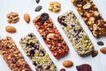 Energy granola bars with different seeds, nuts and dried fruits and berries on white marble background. Healthy snack concept Royalty Free Stock Photo