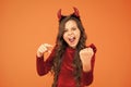 Energy and power. Halloween costumes designed after supernatural figures. Little girl red horns celebrate Halloween