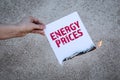 Energy Prices concept. Burning sheet of paper with text