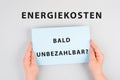 Energy prices soon unaffordable is standing in german language on the paper, increasing prices , high living expenses, gas