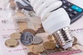 Energy saving concept. Electric light bulb, ruble money and calculator Royalty Free Stock Photo