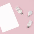 Energy-saving and eco-friendly life in conceptual frame pattern. Creative top view flat lay of LED light bulbs and white paper Royalty Free Stock Photo