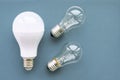 Energy-saving lamp with incandescent lamps on a gray background. The concept of saving energy Royalty Free Stock Photo