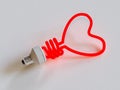 Energy saving lamp in the shape of the heart Royalty Free Stock Photo