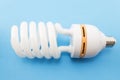 Energy saving light bulb on a blue background Royalty Free Stock Photo