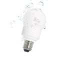 An energy saving light bulb falling into the water Royalty Free Stock Photo