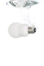 An energy saving light bulb falling into the water Royalty Free Stock Photo