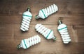 Energy saving light bulbs on wood background Royalty Free Stock Photo