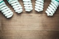 Energy saving light bulbs on wood background Royalty Free Stock Photo