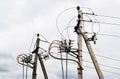 Energy and technology: Two electric poles with power line cables, transformers on a cloudy sky background Royalty Free Stock Photo