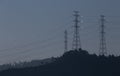 Energy towers during sunset with a vibrant white reflection at the poles on a peaceful blue background, Braga. Royalty Free Stock Photo