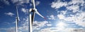 Energy wind turbines on sky with clouds and sun Royalty Free Stock Photo