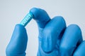 ENERGY is written on blue pill capsule held in the hands of doctor in gloves. closeup