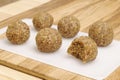 Energyballs candy on a white cutting board lying on a wooden table Royalty Free Stock Photo