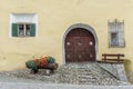 Engadin house architectural detail with cobblestone street and flowers and bench Royalty Free Stock Photo